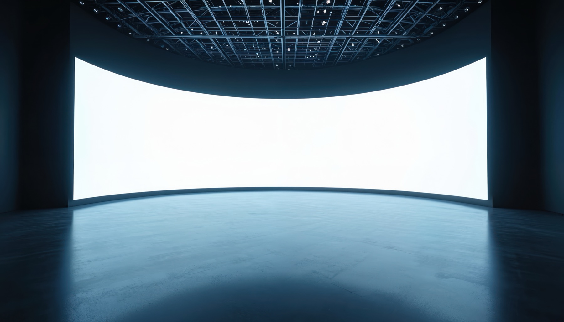 Curved LED XR volume in a studio — a blank wraparound video wall under a lighting-truss grid