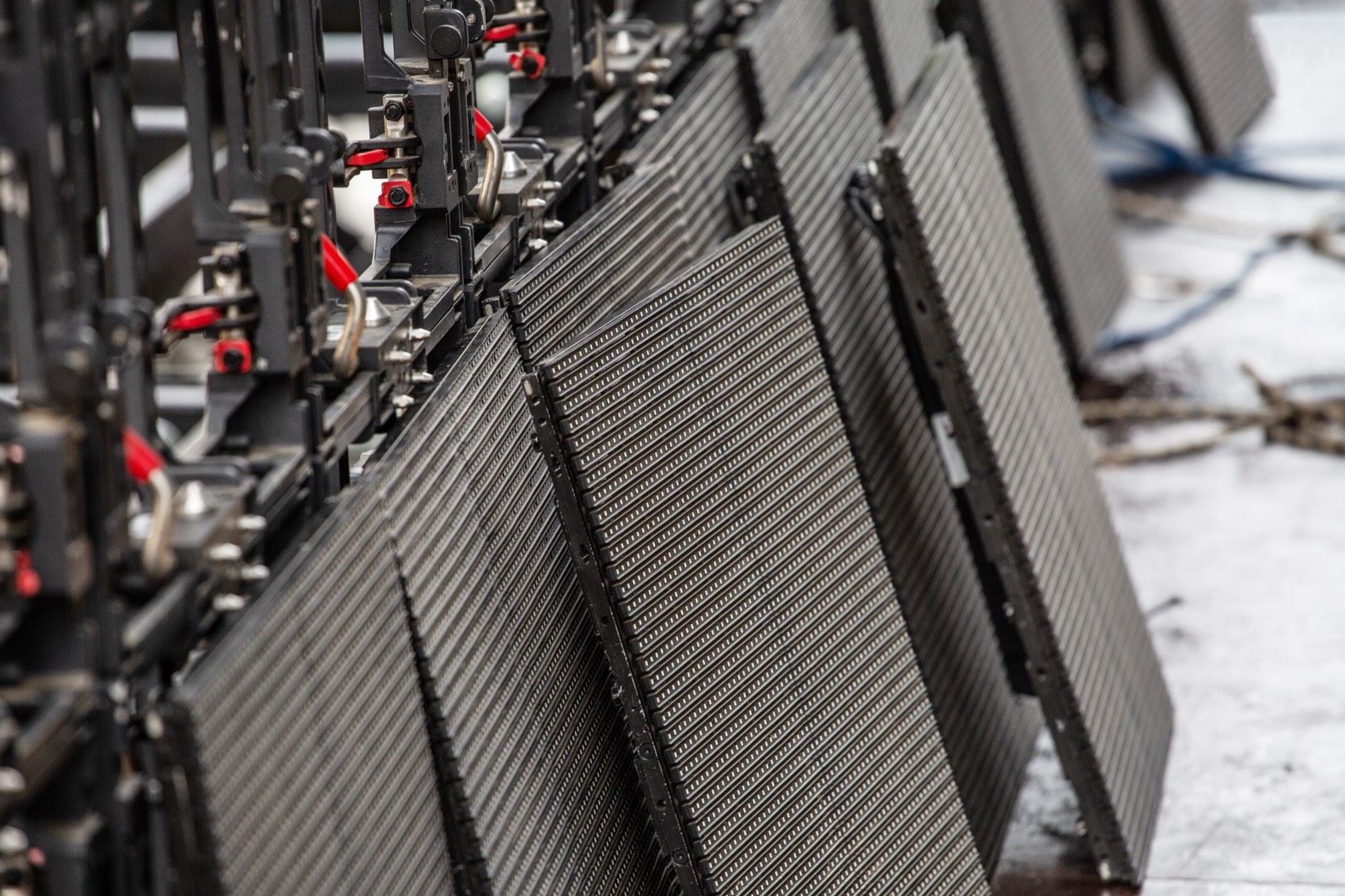 Touring LED panels staged for an arena load-in — road-cased cabinets with pre-wired power and data